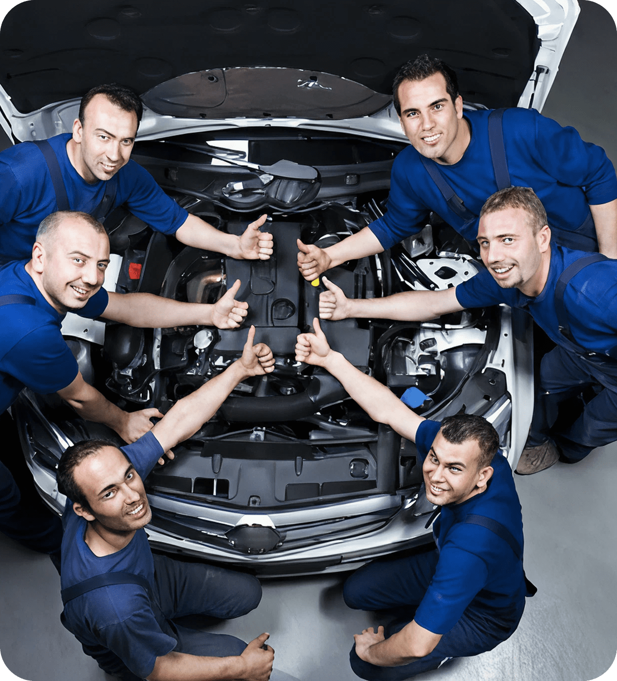 Mechanics giving thumbs up around car engine