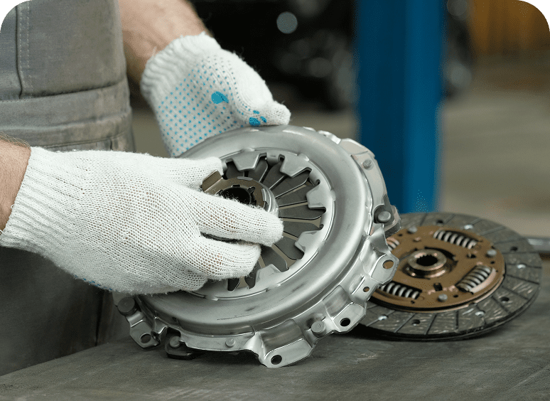 Worker inspecting automotive clutch parts