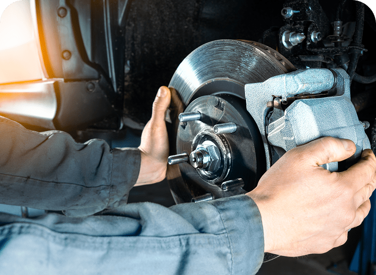 Mechanic working on car brake system